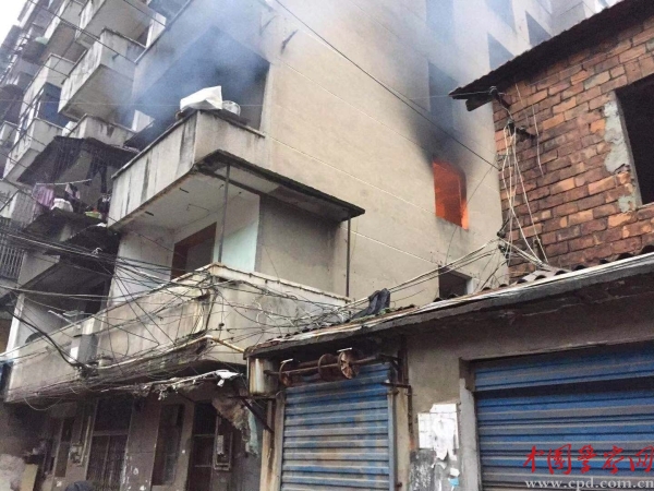 起火的居民房内冒出火光 通讯员 刘芳摄